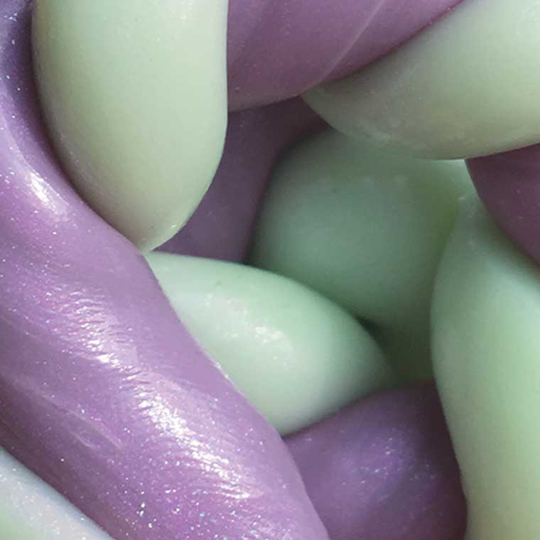 Close up of color changing lilac purple and light green putty.