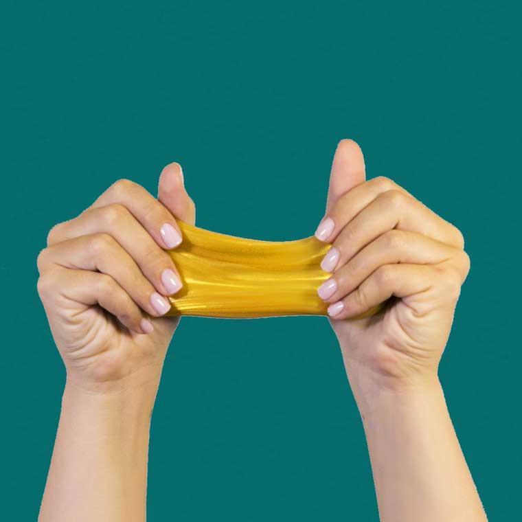 Two hands stretching Real Gold Thinking Putty®.