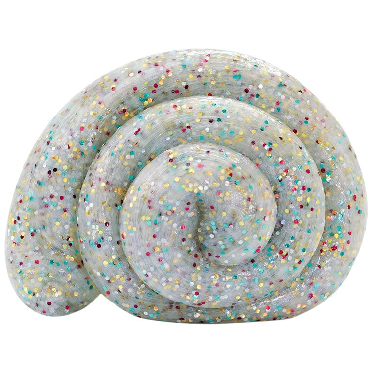 White putty with multicolor glitter shaped into a spiral.