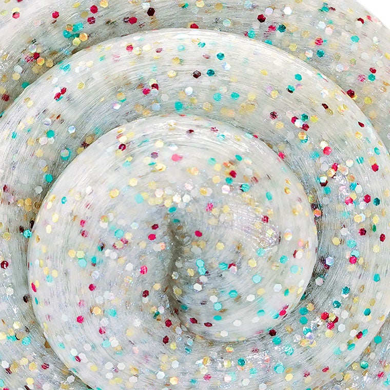 Close up detail of white putty that has multicolor glitter mixed in.