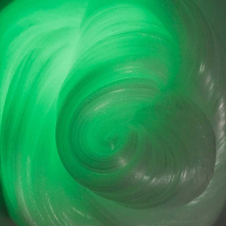 Close up texture of green glowing putty.