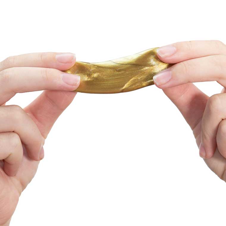 Two hands stretching gold putty.