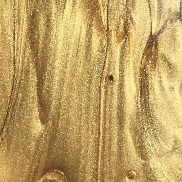 Close up smooth texture of metallic gold putty.
