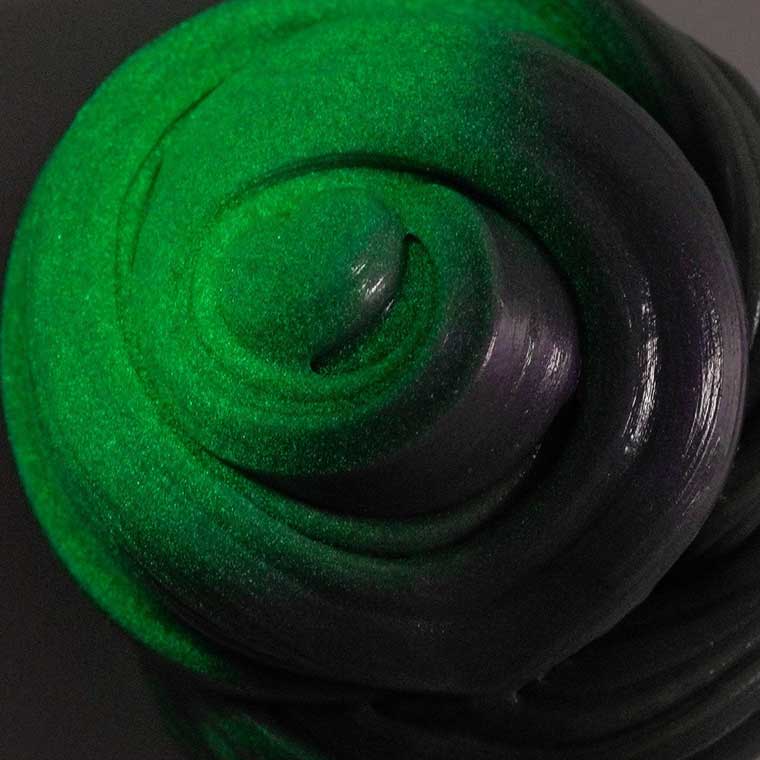 Close up detail of purple putty glowing green in the dark. 