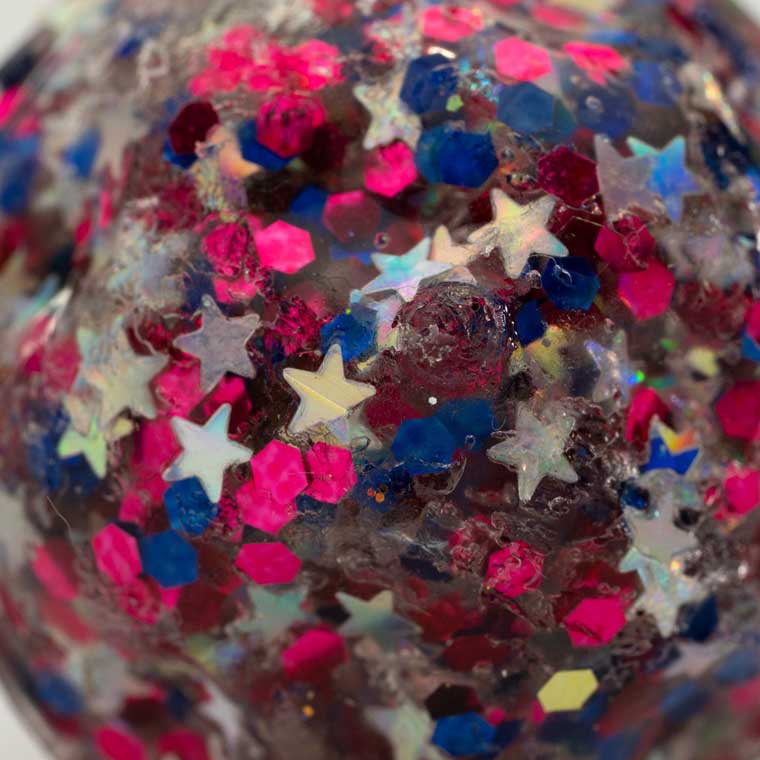 Close up of red, blue and silver glitter X-Ball.